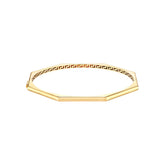 a gold bracelet with a greek key design